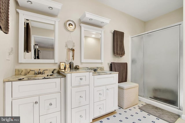 full bathroom with tile patterned floors, vanity, and a stall shower
