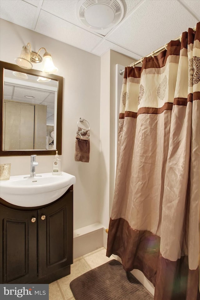 bathroom featuring tile patterned flooring, a shower with shower curtain, and vanity