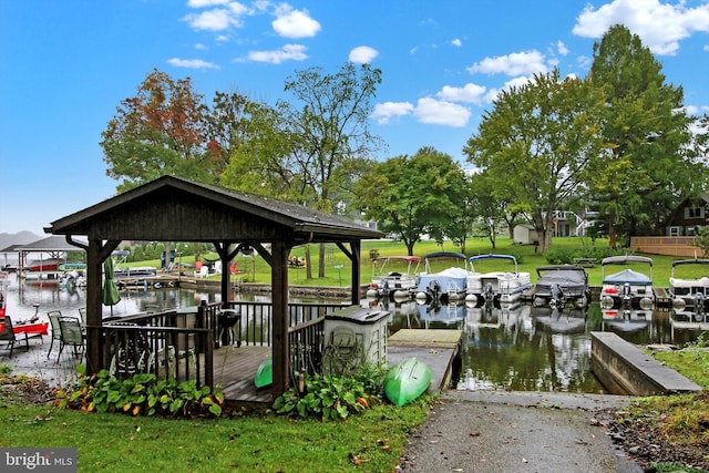 dock area featuring a gazebo, a yard, and a water view