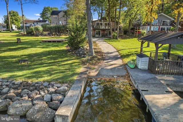 view of home's community featuring a wooden deck and a lawn