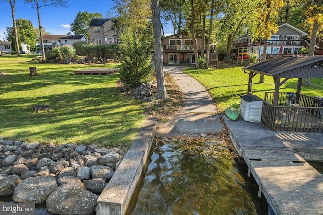 view of community with a yard and a residential view