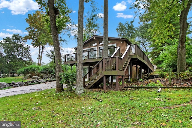 back of property featuring a yard, stairway, and a deck