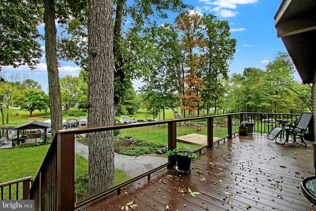 wooden terrace with a lawn