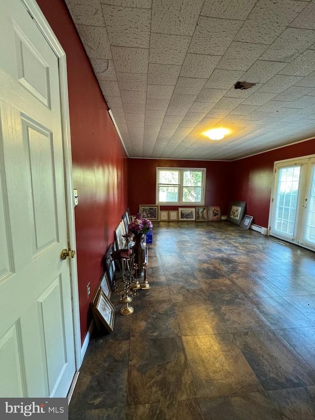 misc room featuring a wealth of natural light and a baseboard heating unit