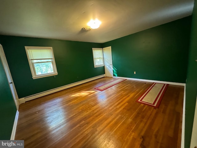 interior space with a baseboard radiator and wood-type flooring