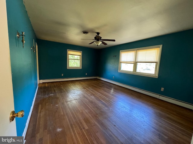 empty room with a baseboard heating unit, hardwood / wood-style flooring, and ceiling fan