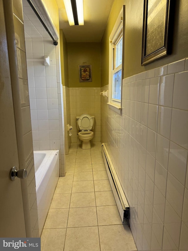 bathroom featuring a bathtub, a baseboard radiator, tile walls, toilet, and tile patterned floors