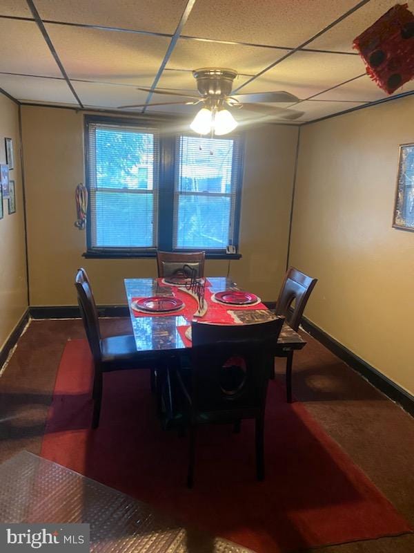 dining area with a paneled ceiling and ceiling fan