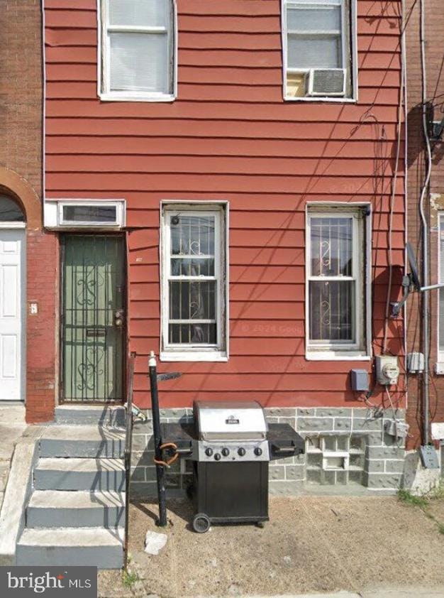 doorway to property featuring cooling unit