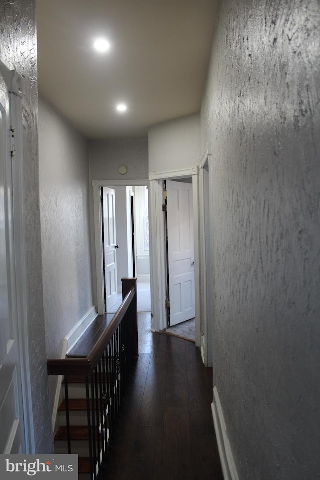 corridor with dark wood-type flooring