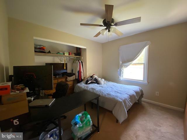 carpeted bedroom with a closet and ceiling fan