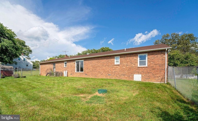 rear view of house with a yard