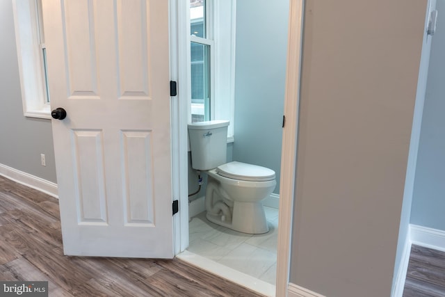 bathroom featuring hardwood / wood-style flooring and toilet