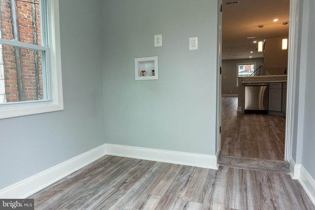 washroom with washer hookup and wood-type flooring