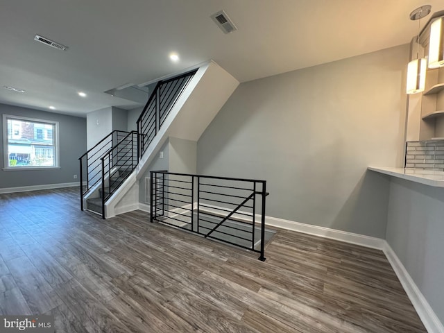 stairs featuring hardwood / wood-style flooring