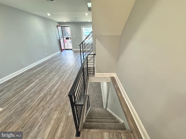 staircase featuring wood-type flooring