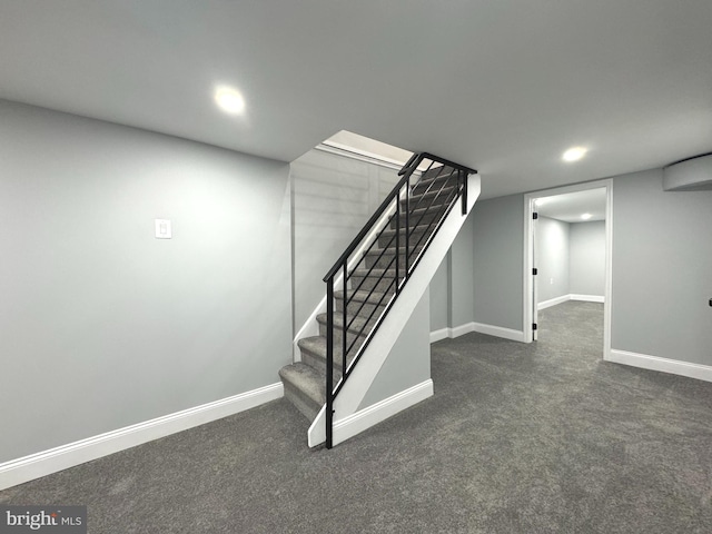 basement with dark colored carpet