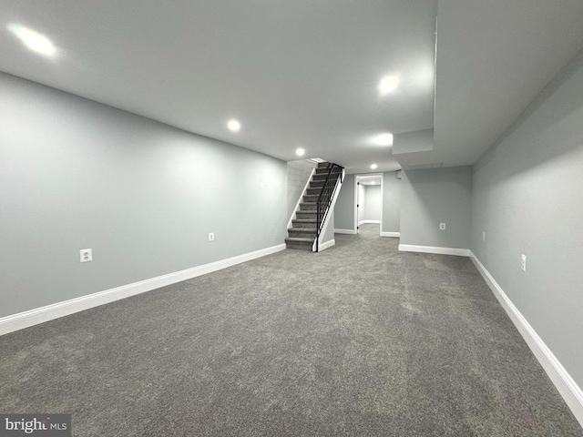 basement featuring dark carpet