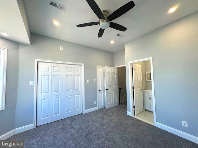 unfurnished bedroom with connected bathroom, light carpet, and ceiling fan