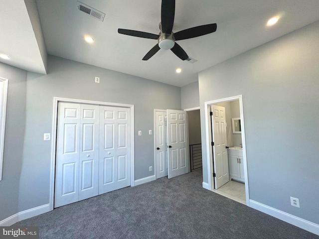 unfurnished bedroom with ceiling fan, light colored carpet, and ensuite bath