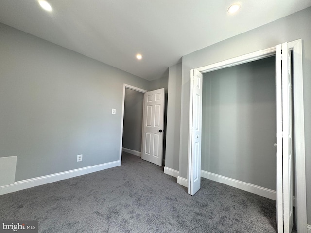 unfurnished bedroom featuring dark colored carpet