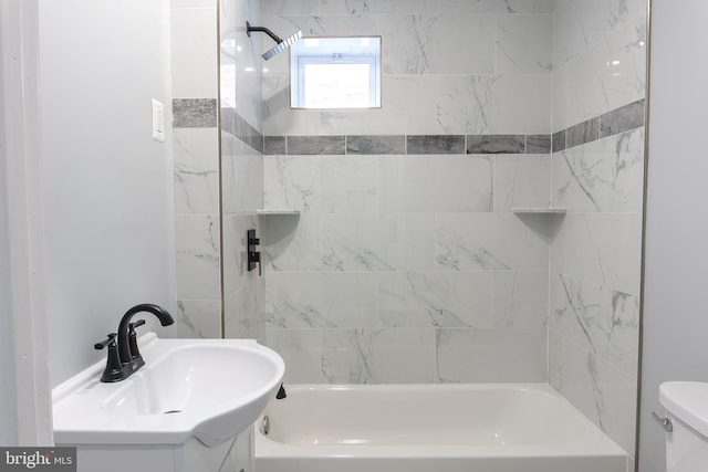 full bathroom with vanity, tiled shower / bath combo, and toilet