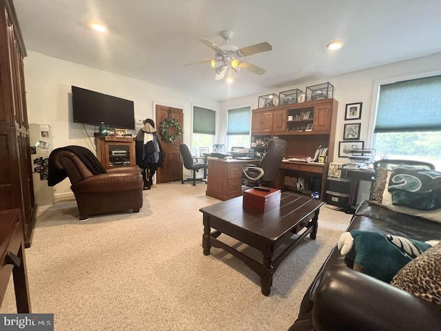 living room featuring ceiling fan and light colored carpet