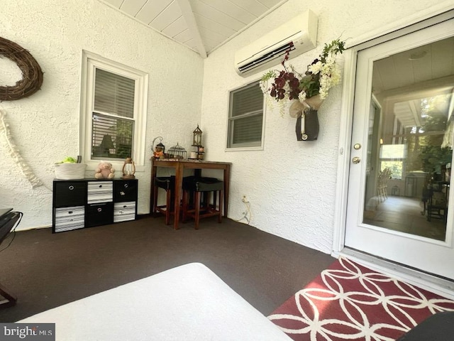 view of patio with an AC wall unit