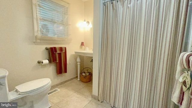 bathroom featuring tile patterned flooring and toilet