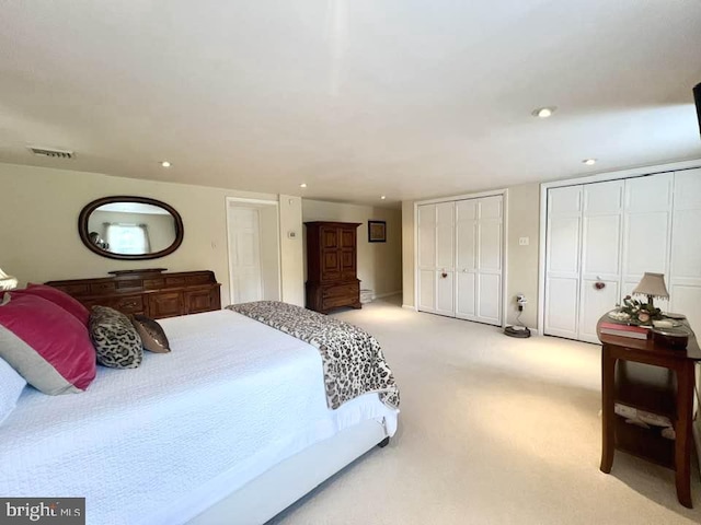 carpeted bedroom featuring multiple closets