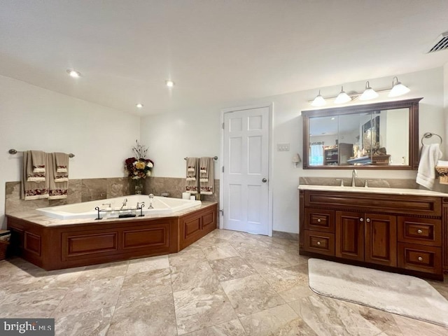 bathroom with a bath and vanity