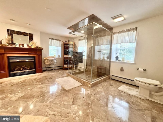 bathroom featuring a shower with door, toilet, and a baseboard heating unit