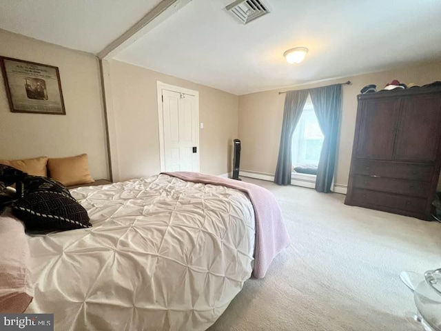 carpeted bedroom featuring baseboard heating