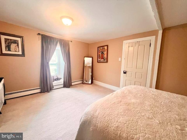 carpeted bedroom with a baseboard heating unit and a closet