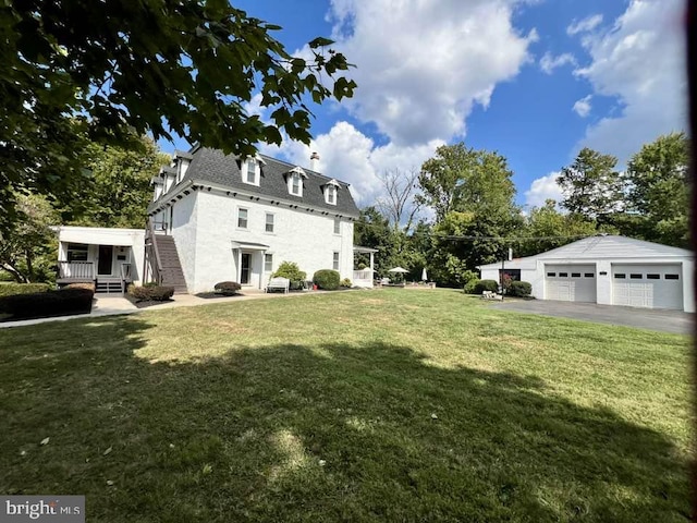 view of yard with an outbuilding and a garage