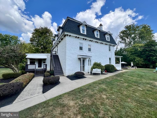 back of house with a lawn