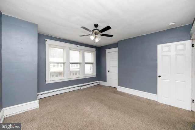 carpeted empty room featuring ceiling fan and a baseboard heating unit