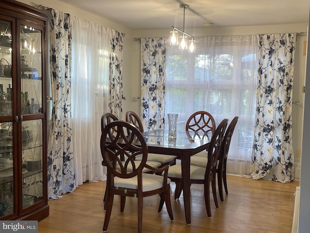 dining space featuring a wealth of natural light, a chandelier, and light hardwood / wood-style floors