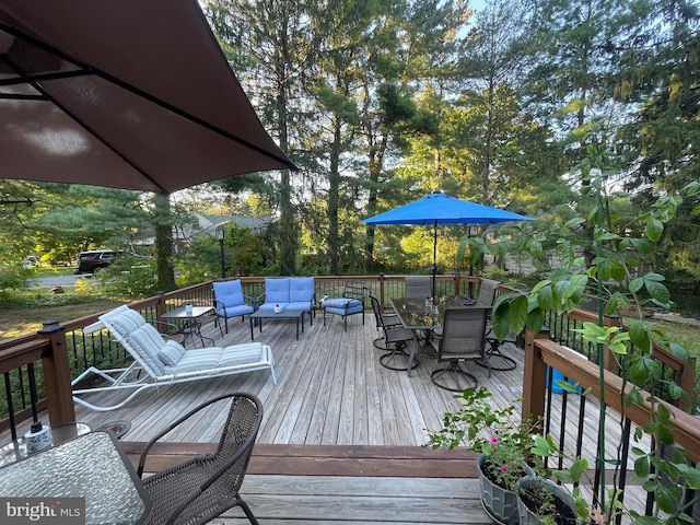 wooden terrace with an outdoor hangout area