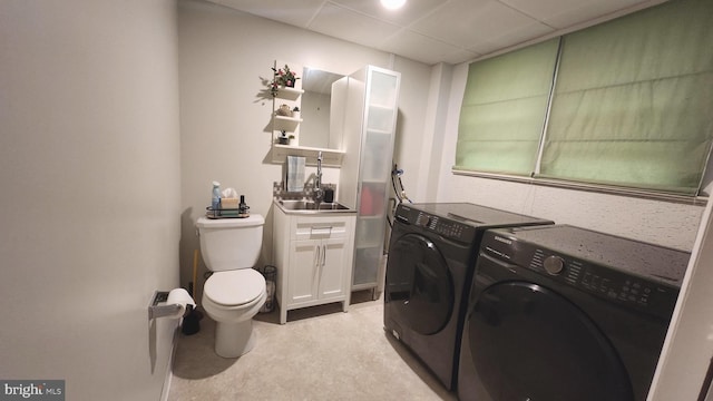 washroom featuring sink and independent washer and dryer