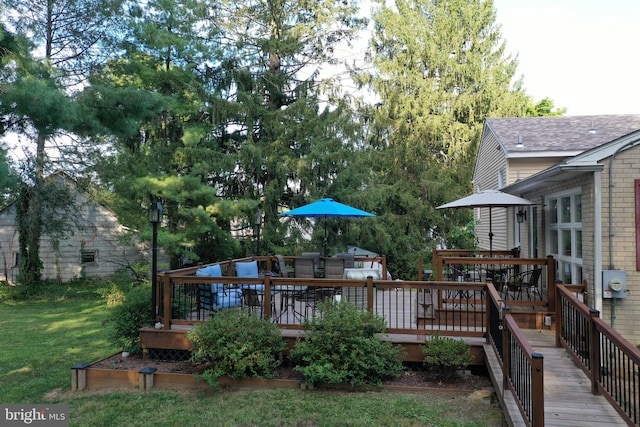 wooden deck featuring a yard