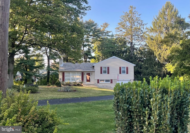 tri-level home with a front yard