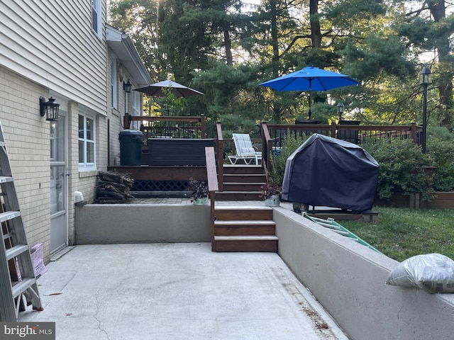 view of patio with grilling area and a wooden deck