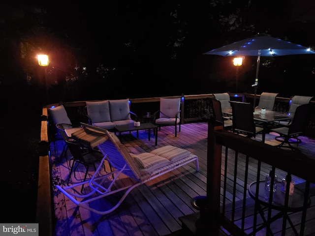 deck at night with an outdoor hangout area