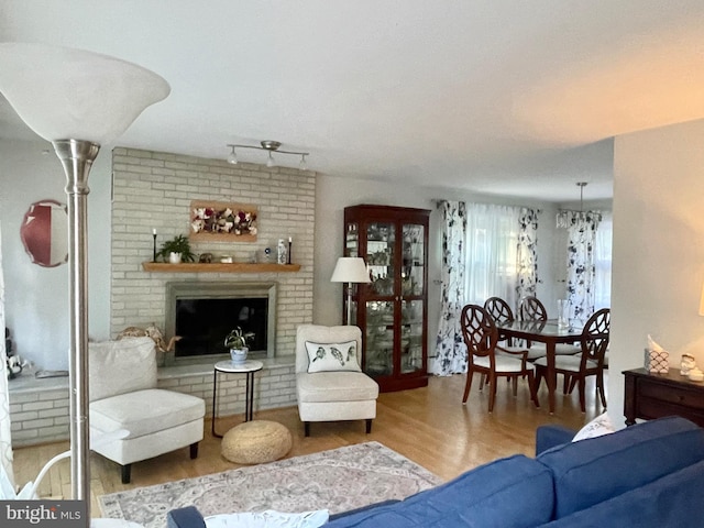 living room featuring hardwood / wood-style floors and a brick fireplace