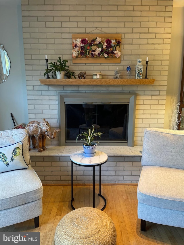 living room with light hardwood / wood-style floors and a fireplace