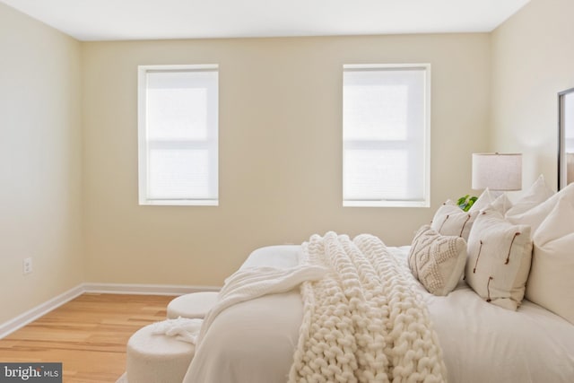 bedroom featuring wood-type flooring and multiple windows