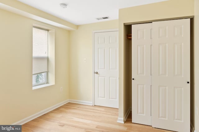 unfurnished bedroom featuring a closet and light hardwood / wood-style floors