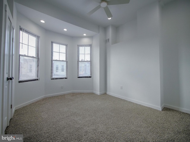 empty room with carpet flooring and ceiling fan