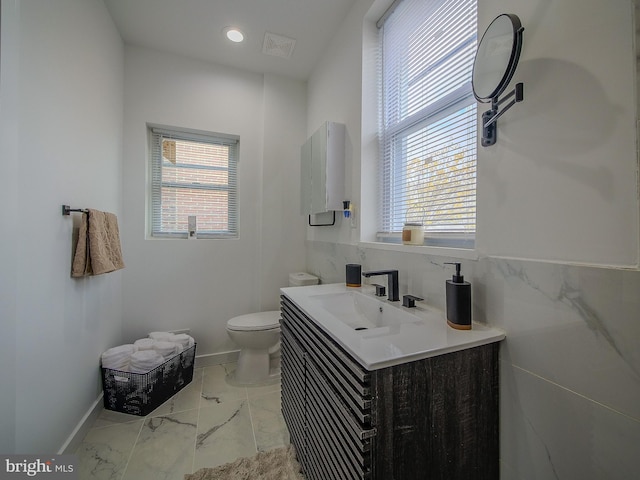 bathroom featuring vanity and toilet